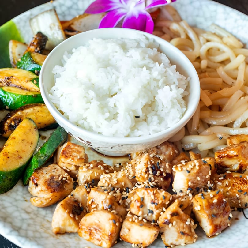Rio of Japan's chicken teriyaki with rice, grilled zucchini, onions, and udon noodles.