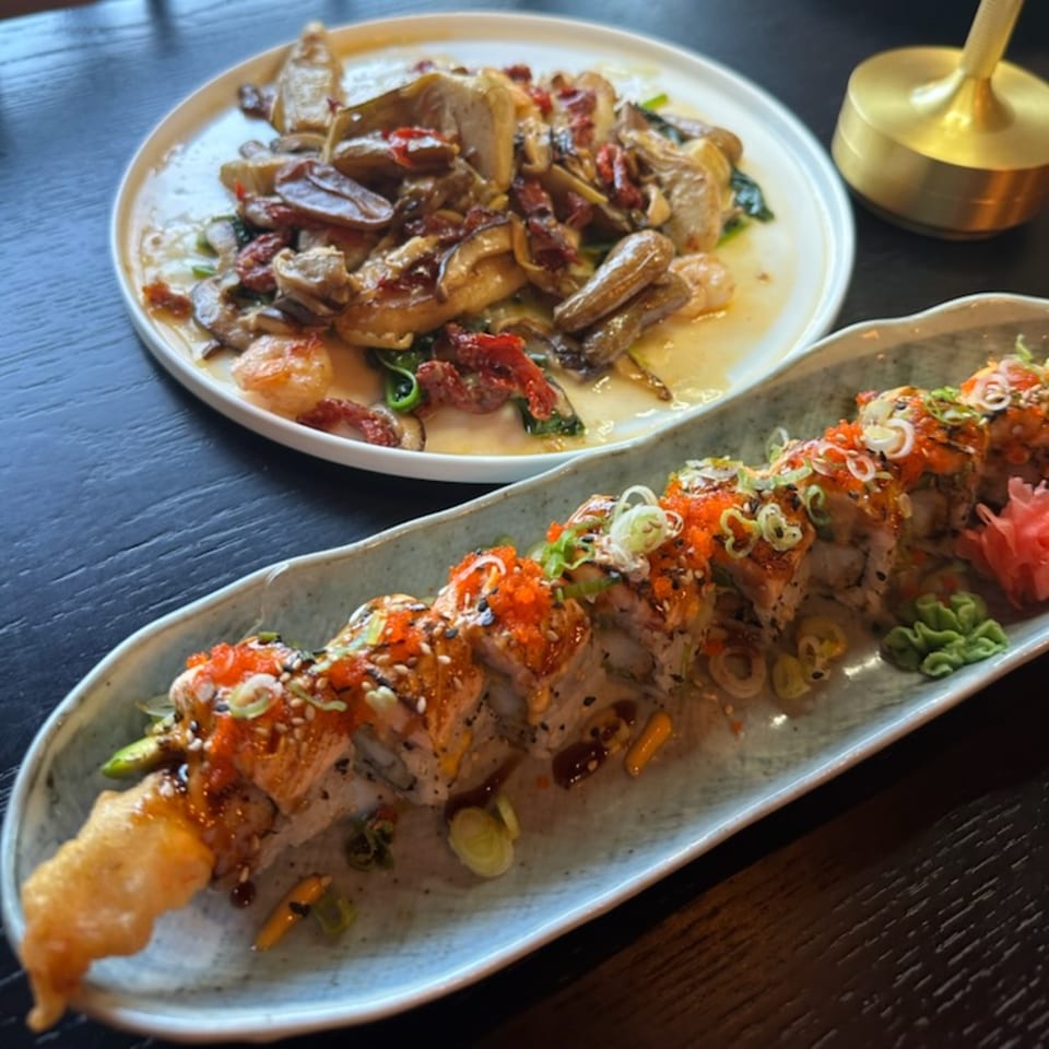 Rio of Japan sushi roll with red roe, scallions, and a side dish of mushrooms and shrimp.